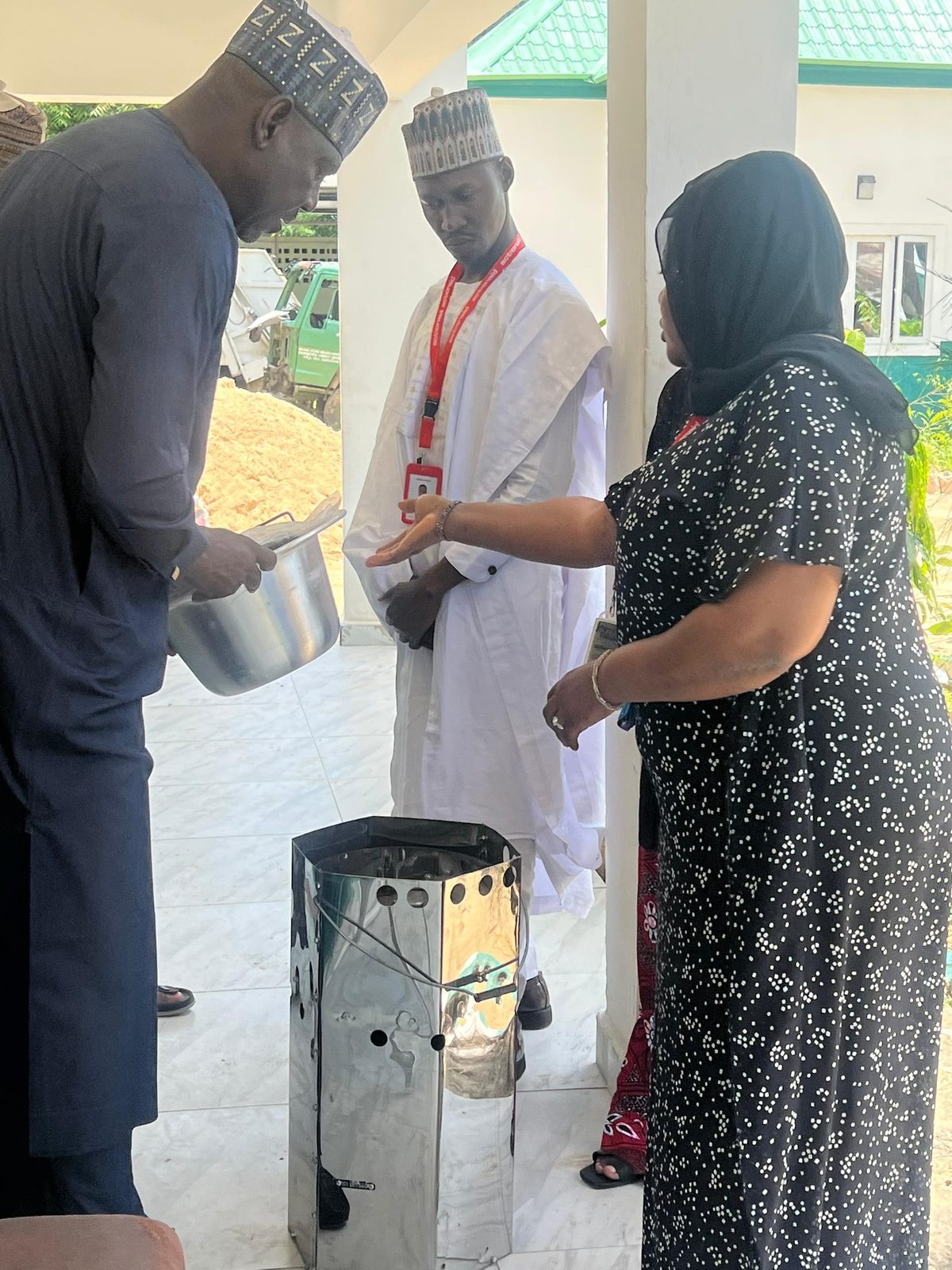 Reviewing a clean-cooking stove with a partner organisation during the participatory review and reflection visit to Borno State
